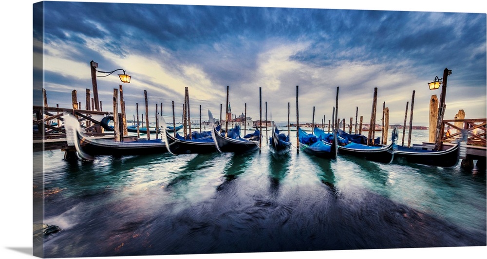 Sunset panorama with gondolas in Venice, Italy