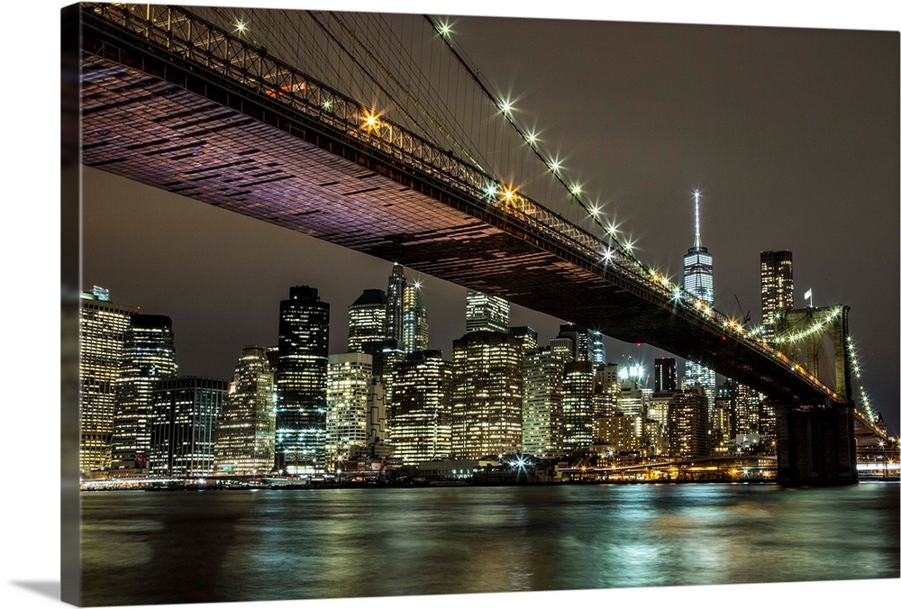 The Brooklyn Bridge and view of NYC after dark.