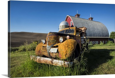 Vintage pickup truck and red barn in the Palouse region of Washington