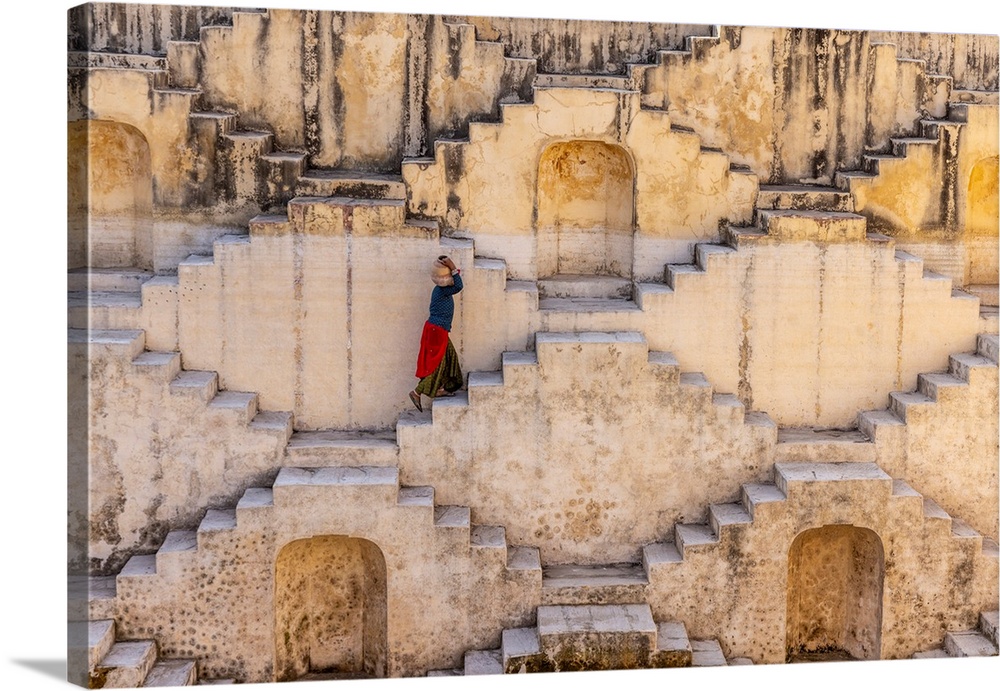 woman carrying jug of water at stepwell in jaipur, india