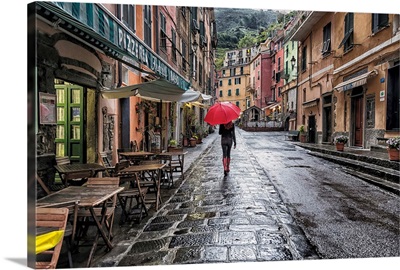 Woman with red umbrella in the rain in Vernazza, Italy