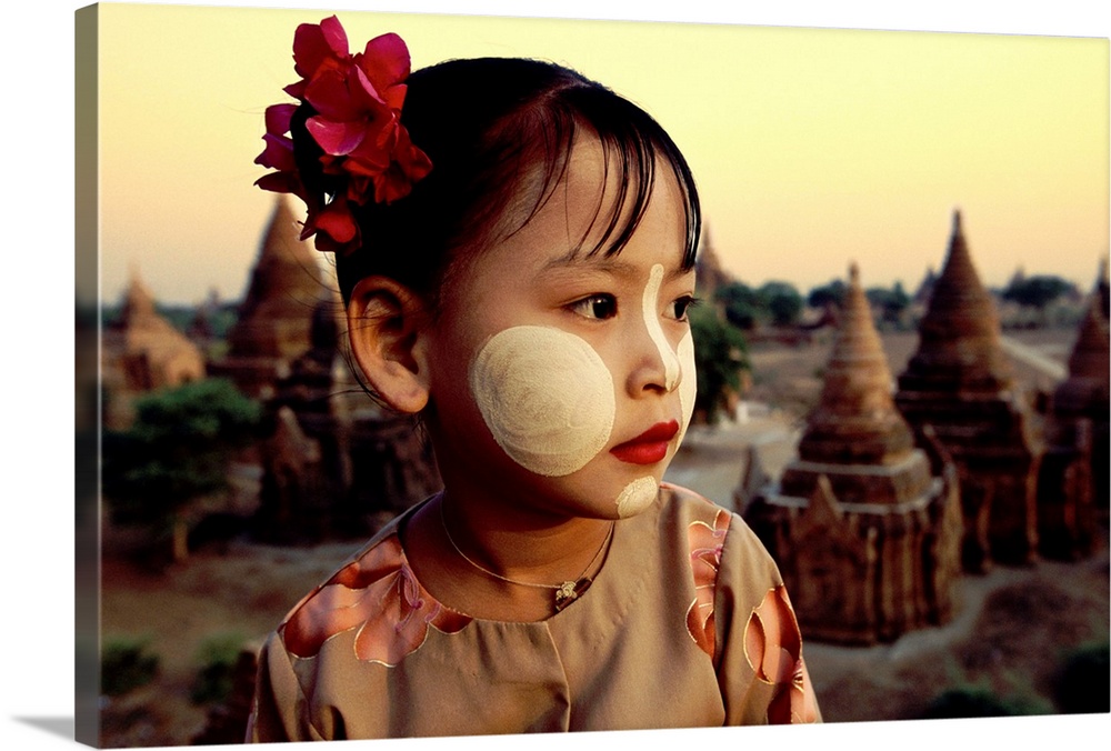 Young Burmese Girl with tanaka facepaint above the temples of Bagan, Burma