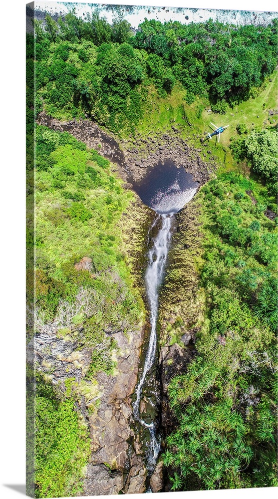 Big Island Hawaii. A blue Hawaiian helicopter sets down on a remote waterfall near the pristine big island's northeastern ...