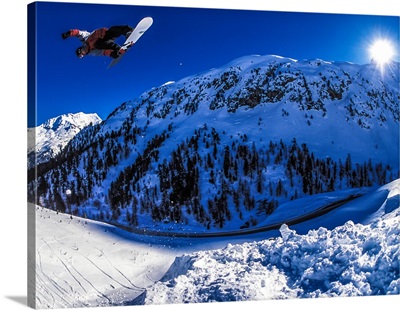 Dave Aubrey snowboarding over Julier Pass in the Swiss Alps