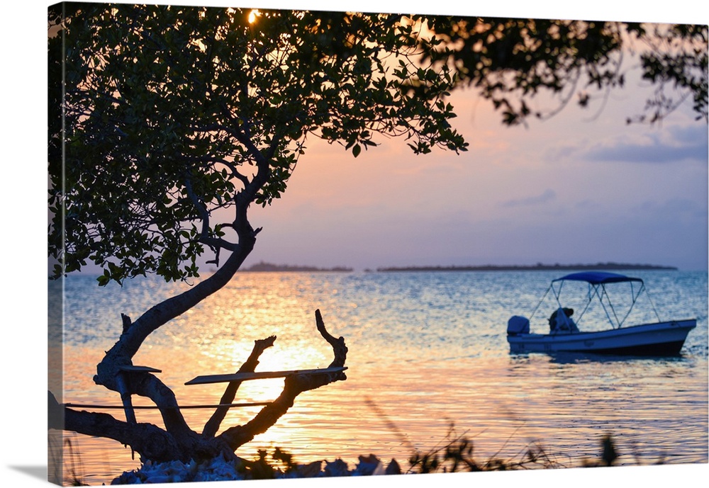 Southern Belize. The sun sets over an insecure fishing perch on Buttonwood Caye in southern Belize.