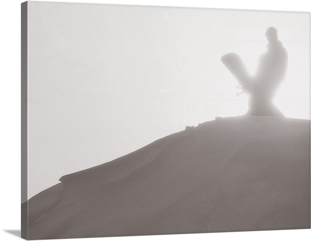 Travis Parker stands with his snowboard in the sunlight at Donner Summit, California, 2002.
