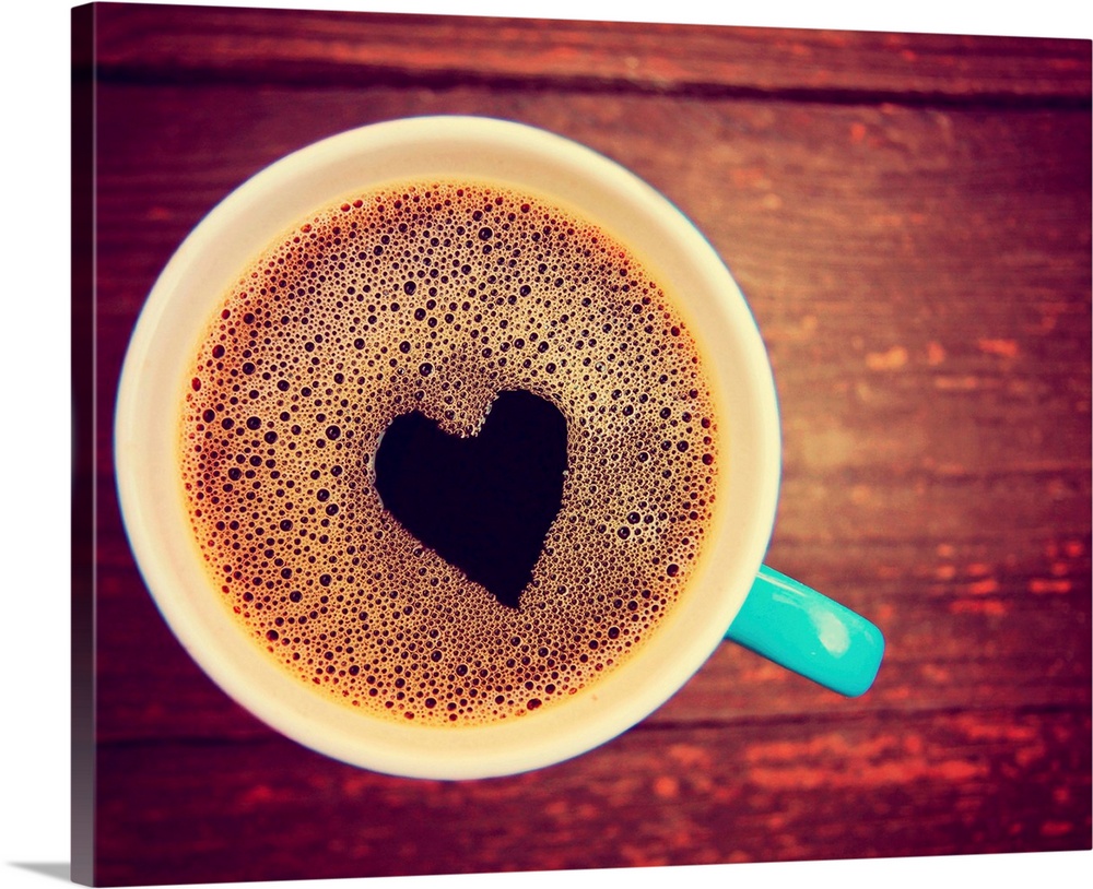 a cup of coffee with a heart shape toned with a retro vintage look