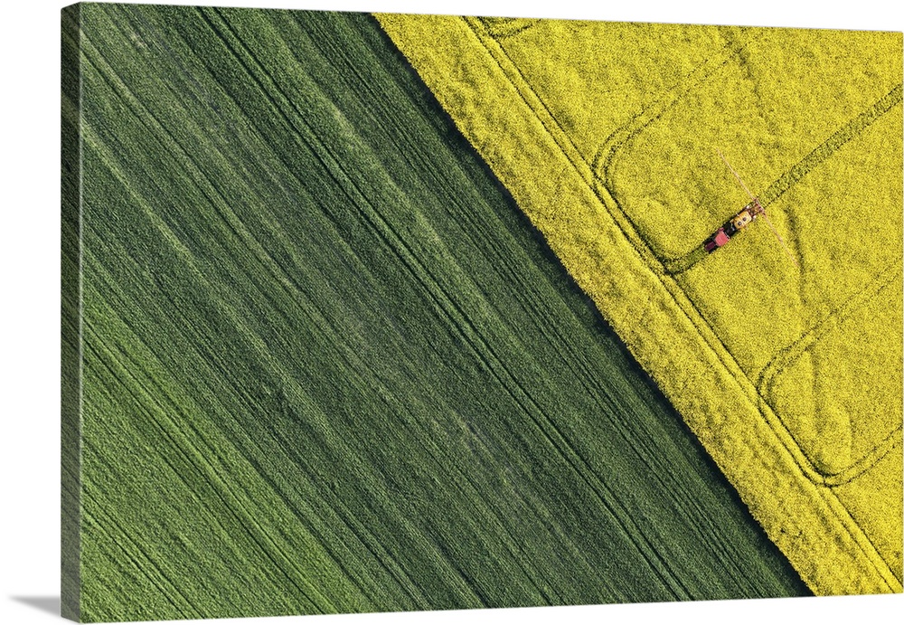 Aerial view of harvest fields with tractor in Poland.