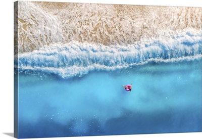 Aerial View Of Woman With Donut Float In The Transparent Blue Sea At Sunset In Summer