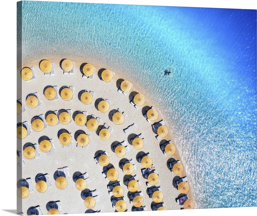 Aerial view of blue sea, empty sandy beach with sun beds and umbrellas at sunset in summer. Blue lagoon in Oludeniz, Turke...
