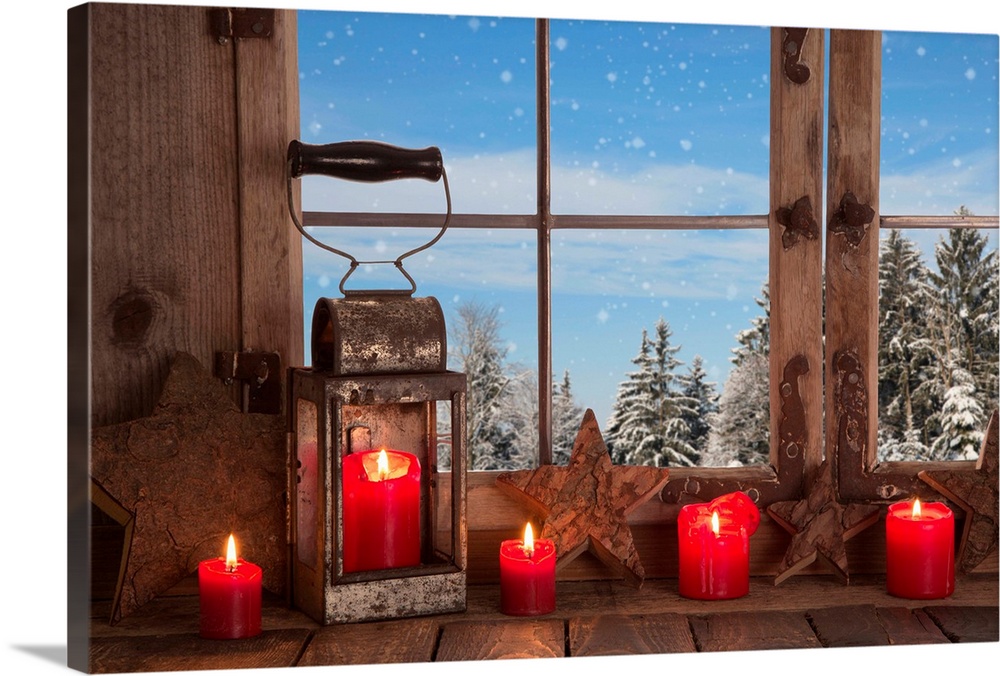 Country Christmas decoration: wooden window decorated with red candles and lantern.