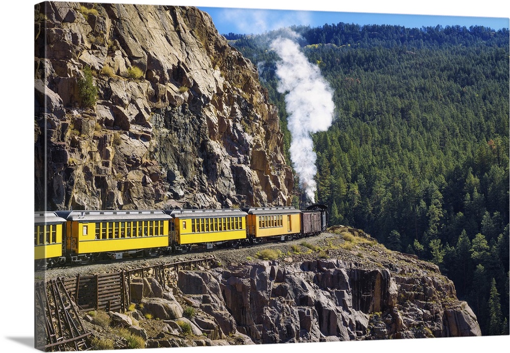 Historic steam engine train travels from Durango to Silverton through the San Juan Mountains in Colorado, USA.
