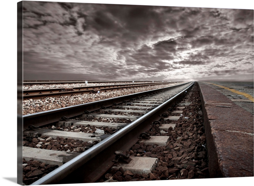 empty railway tracks in a stormy landscape