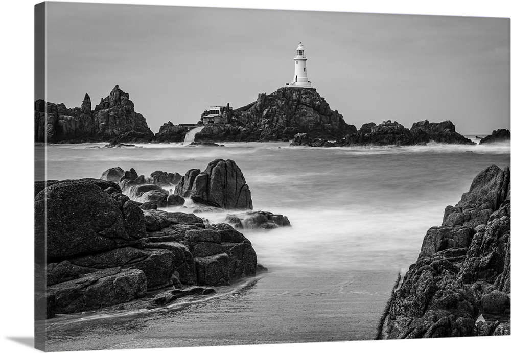 High tide covers the causeway leading to La Corbiere lighthouse, Jersey, Channel Islands, UK.