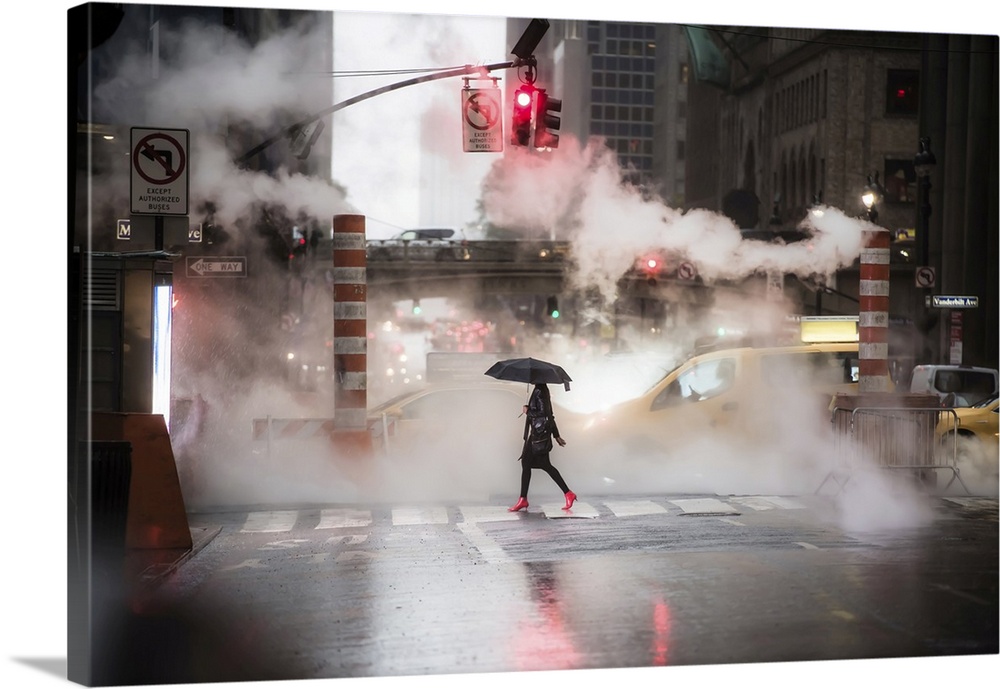 A woman with an umbrella and red high heels shoes is crossing the 42nd street in Manhattan. Taxi and steam coming out from...