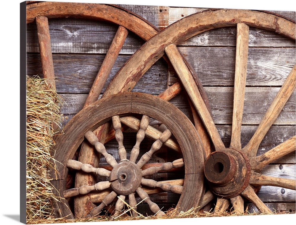Old wheels from a cart in shed.