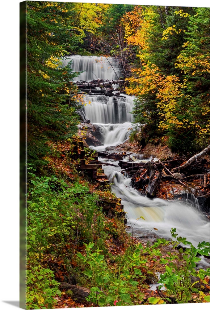 Sable Falls, a waterfall in Upper Peninsula Michigan's Pictured Rocks National Lakeshore is surrounded by fall color and e...