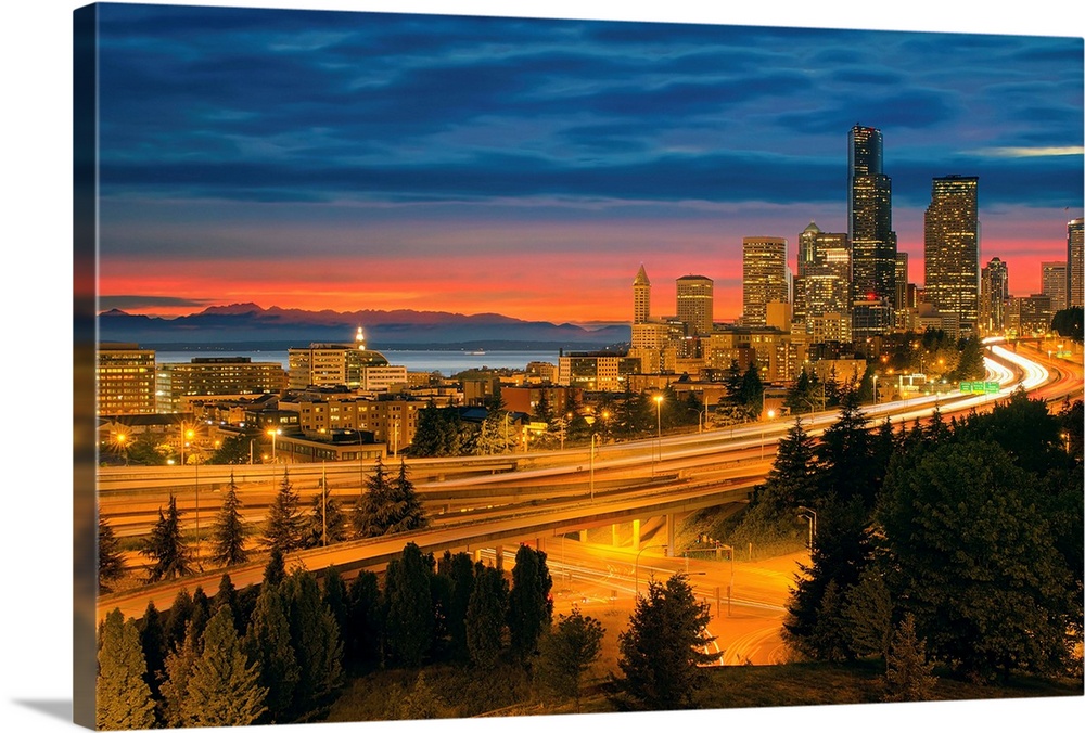 Seattle Washington City Skyline with Freeway Light Trails After Sunset.