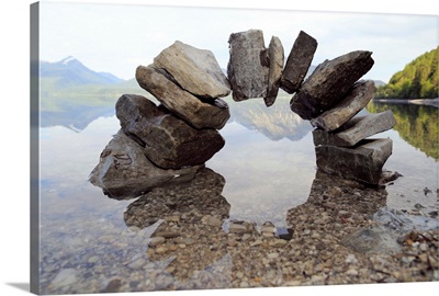 Small stone arch casting reflecting in water