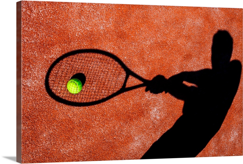 shadow of a tennis player in action on a tennis court (conceptual image with a tennis ball lying on