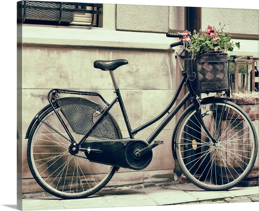 Vintage stylized photo of Old bicycle carrying flowers as decoration.