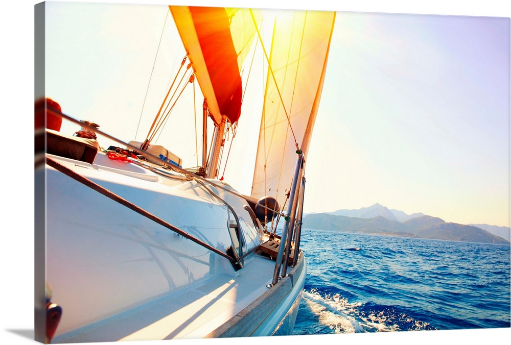 Yacht Sailing against sunset. Sailboat. Yachting. Sailing. Travel Concept. Vacation