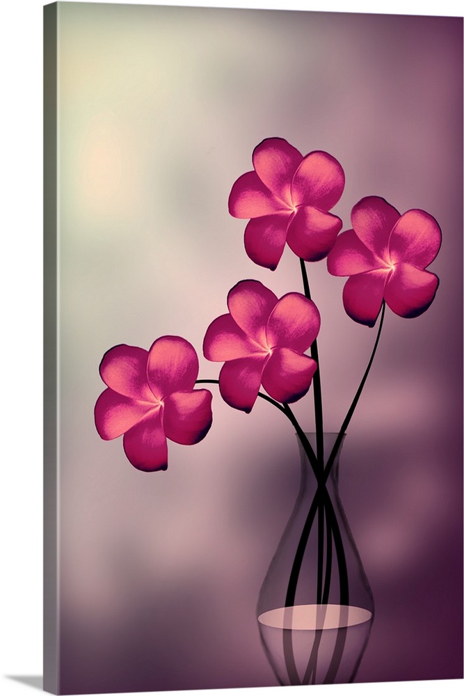 Four pink flowers in a clear glass vase.