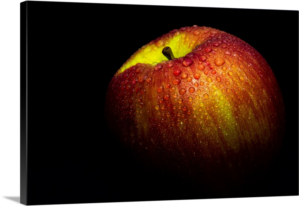 A close up photograph of a fresh Gala apple with waterdrops.