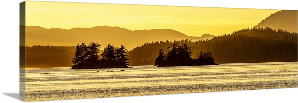 A evening golden sunset overlooking islands and mountains of the Pacific Northwest of Vancouver Island, Canada.