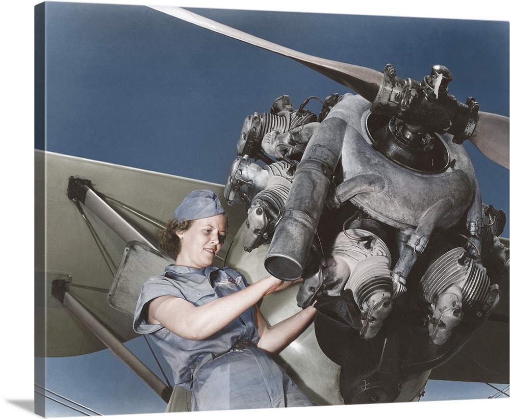 August 1942 - A 20 year old woman and expert aviation mechanic rebuilding an airplane engine. This photo has been digitall...