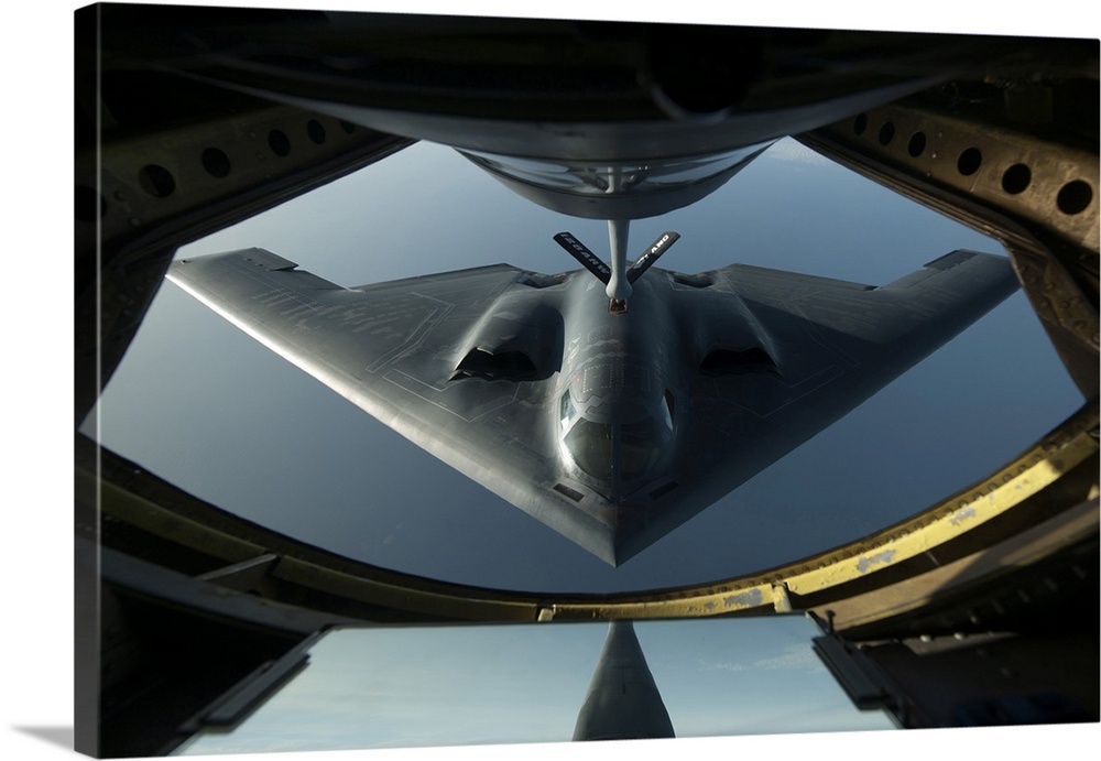 A B-2 Spirit flies into position during a refueling mission.