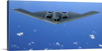 A B-2 Spirit soars through the sky after a refueling mission