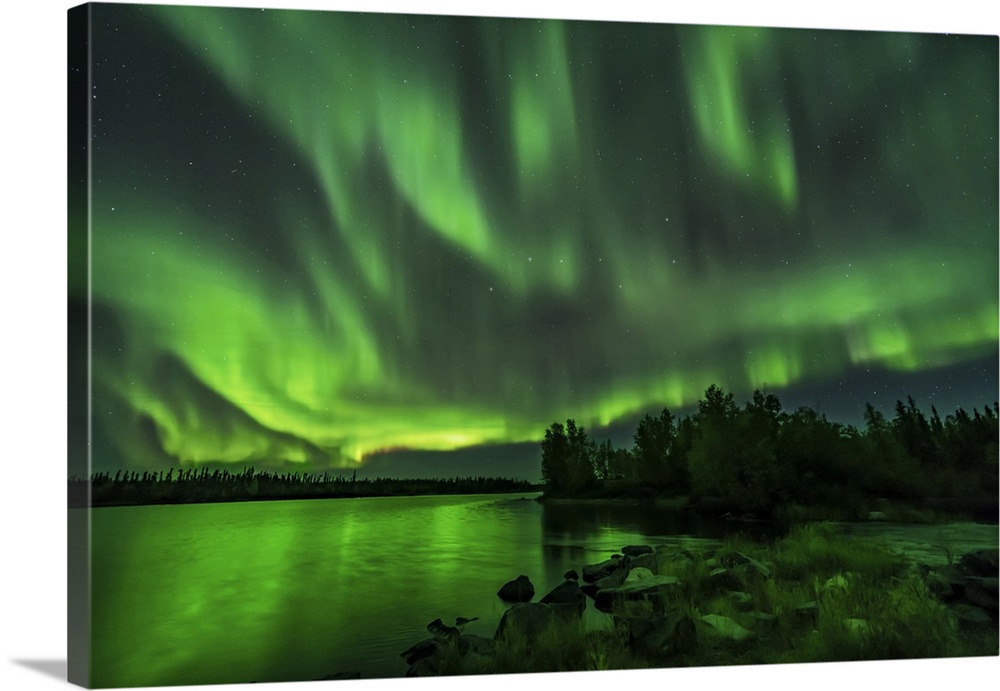 A bright sky-filling aurora at Tibbitt Lake east of Yellowknife, Canada.