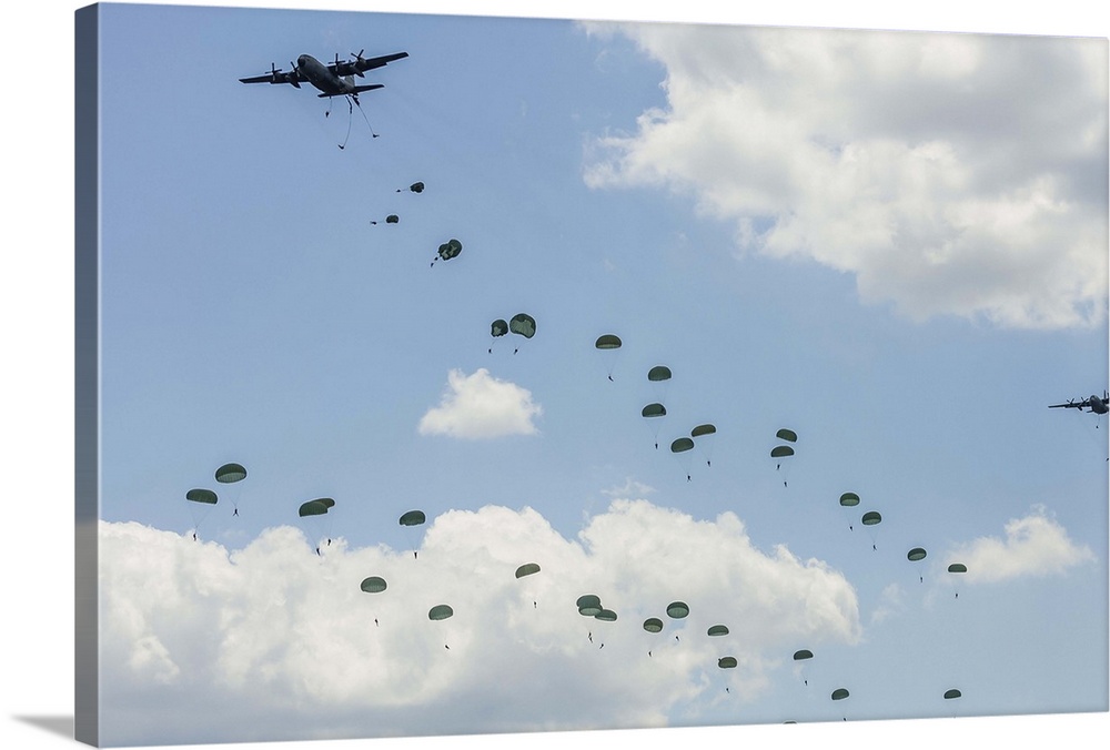 U.S. Air Force C-130 Hercules drop U.S. Army airborne troops over Andrews Air Force Base, Maryland.