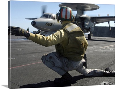 A Catapult Shooter Signals The Launch Of An E-2C Hawkeye