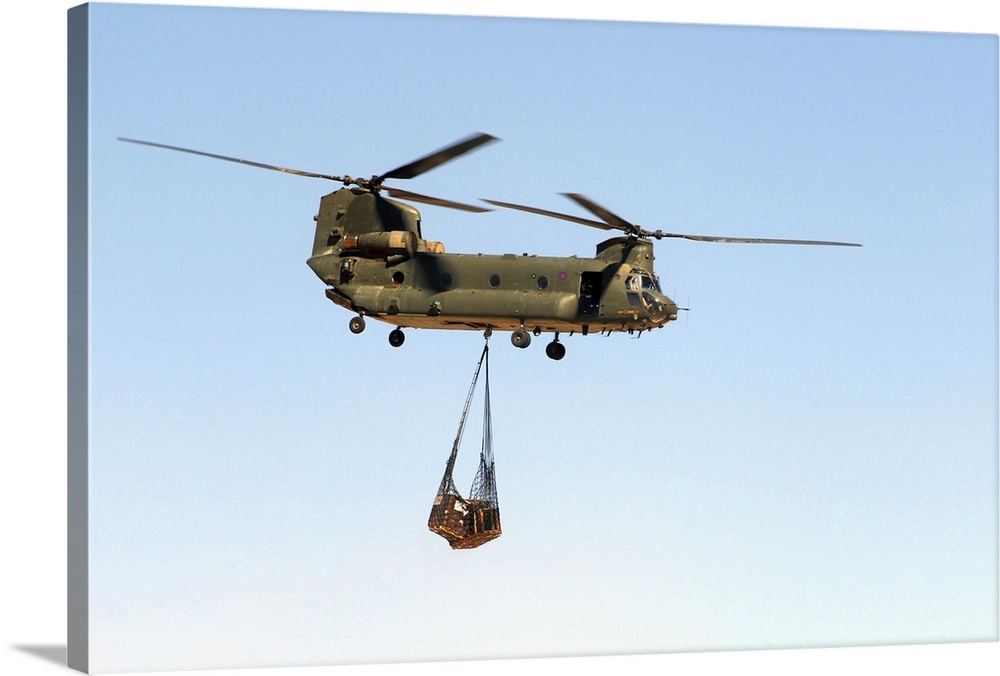 A CH-47 Chinook of the Royal Air Force transports a sling load of pallets.