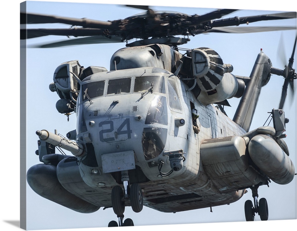 A CH-53 Super Stallion takes off from the flight deck of USS Green Bay.