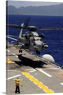 A CH-53E Super Stallion helicopter practices landing aboard USS Essex