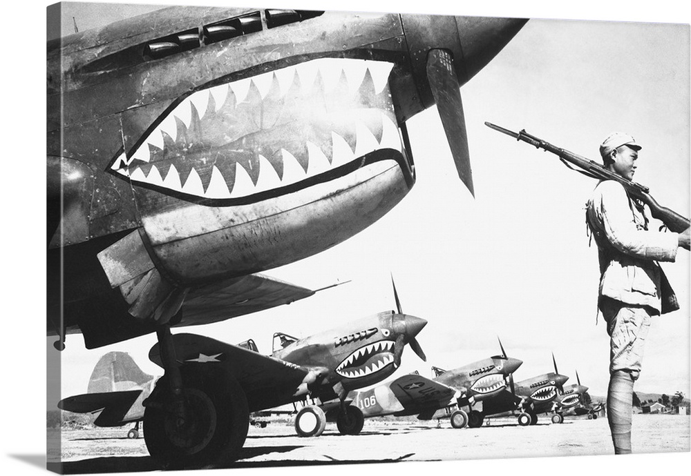 A Chinese soldier guards a line of American P-40 fighter planes during WWII, 1942.