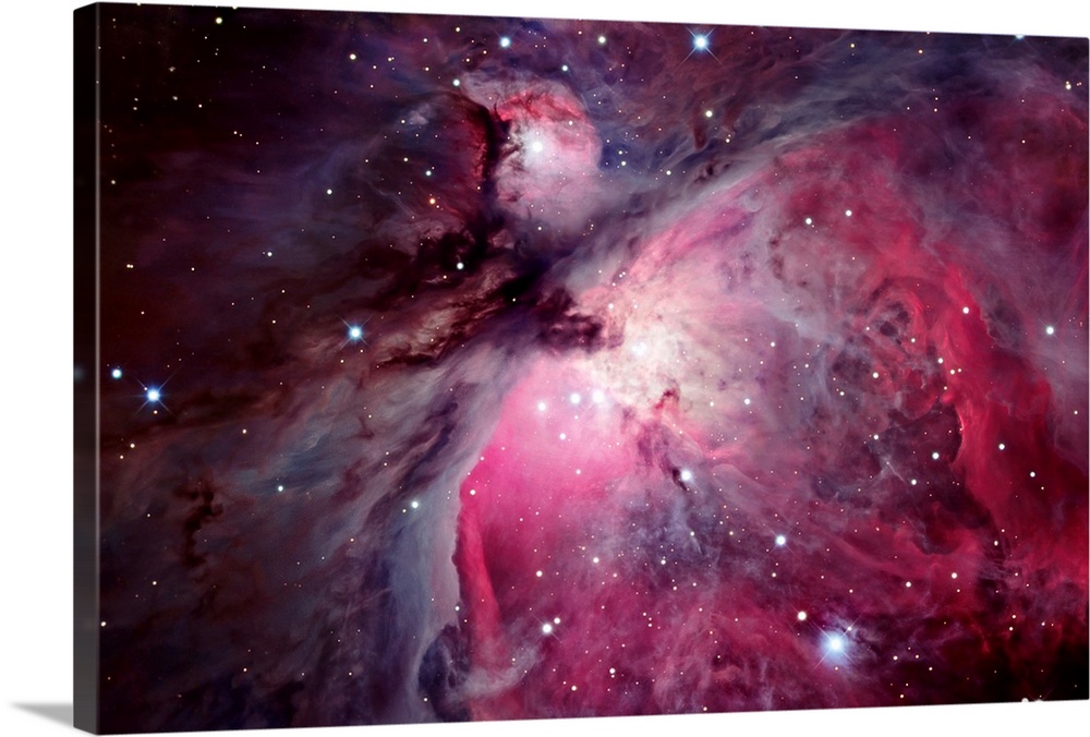 Close shot of the Orion Nebula in outer space. Many shining stars visible.
