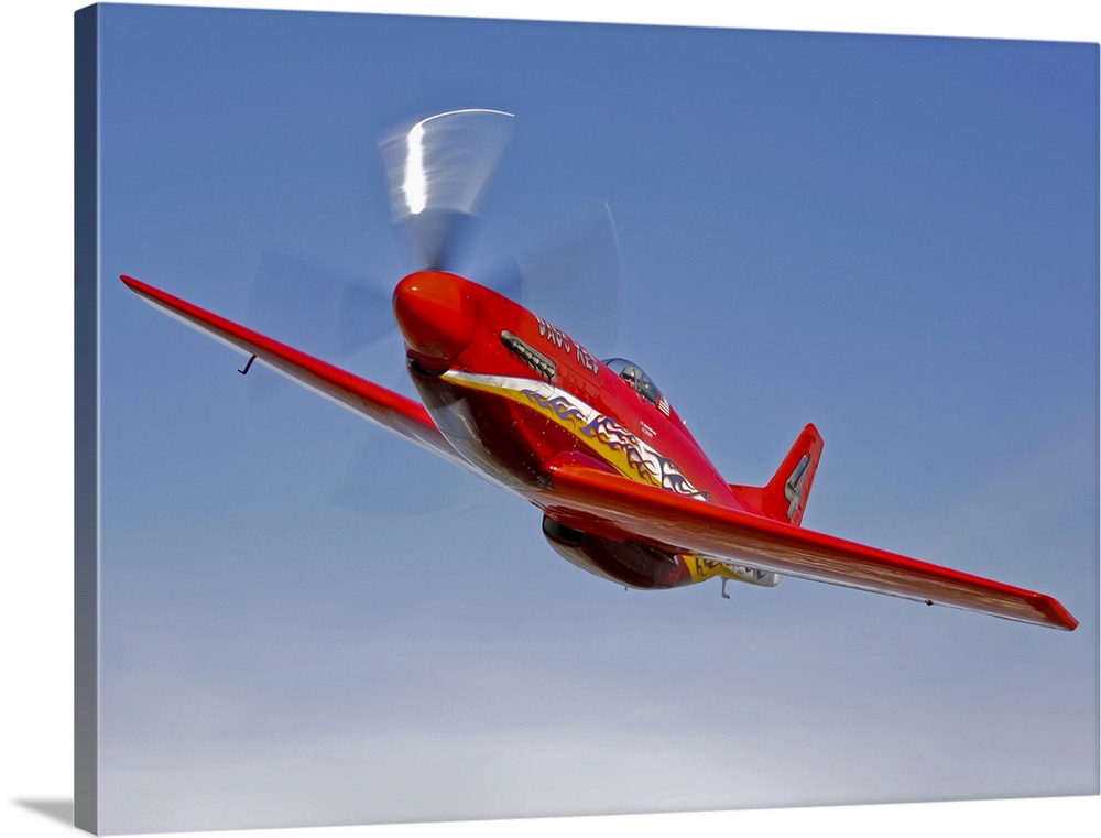 A Dago Red P-51G Mustang modified for competitive air racing, in flight over Hollister, California.