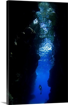 A diver explores the Lerus Cut underwater cavern, Solomon Islands