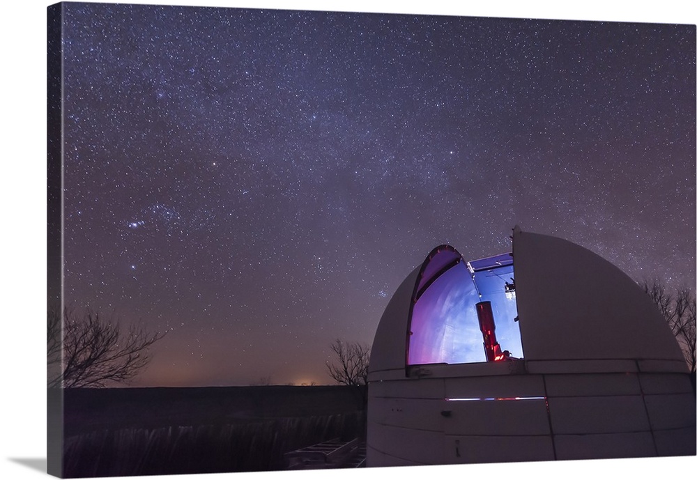A domed observatory is open for business as a refractor telescope surveys the heavens, Crowell, Texas.