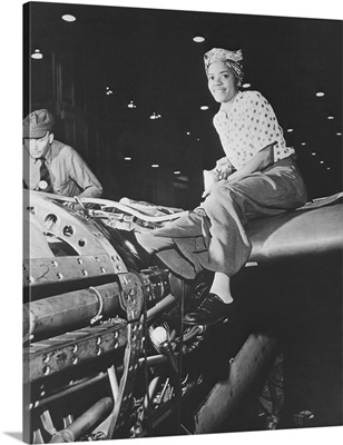 A female riveter working on the fabrication of an airplane