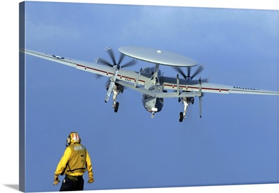 A Flight Deck Director Watches An E-2C Hawkeye Taking Off