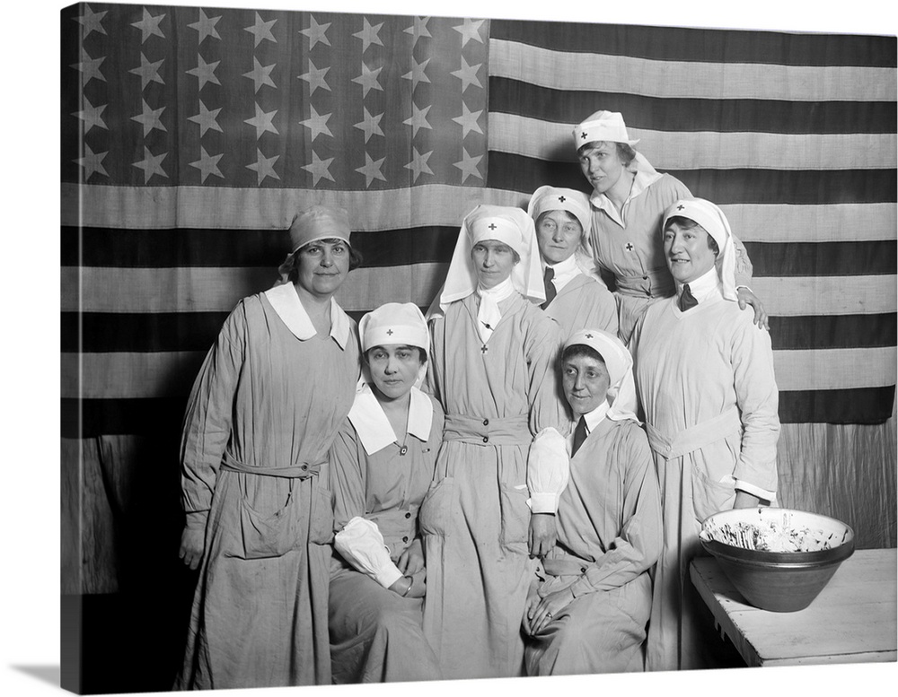 A group of American Red Cross workers standing with The American Flag, Paris, 1919.