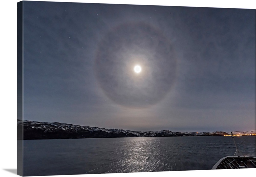 A halo around the nearly full moon over the Barents Sea in northern Norway.