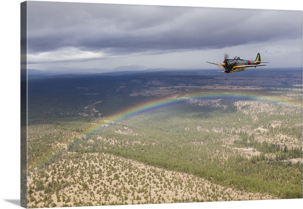 A Japanese A6M Zero and a Ki-43 Oscar fly in formation above a rainbow over Madras, Oregon.