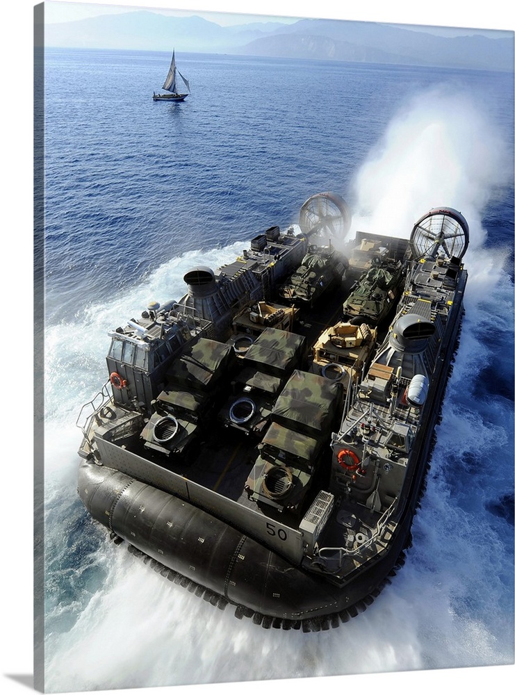 A Landing Craft Air Cushion exits the well deck of USS Bataan.