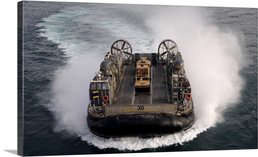 Arabian Gulf, March 25, 2012 - A landing craft air cushion prepares to enter the well deck of the amphibious assault ship ...